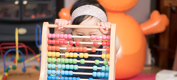 baby playing with abacus
